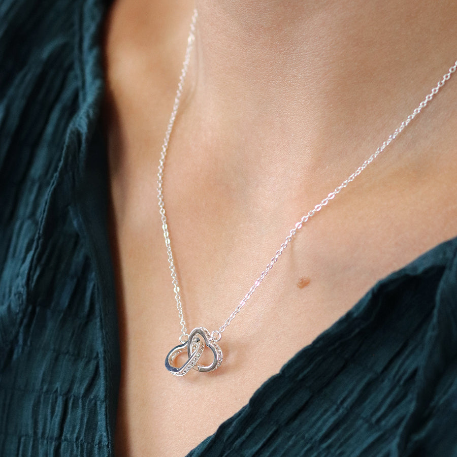 Silver plated crystal edged linked hearts necklace