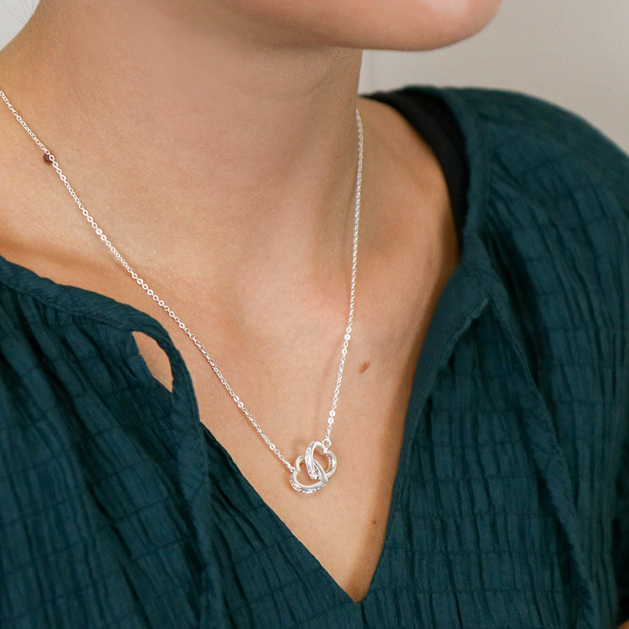 Silver plated crystal edged linked hearts necklace
