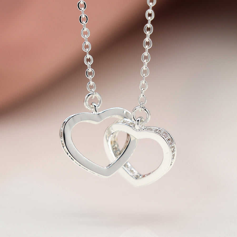 Silver plated crystal edged linked hearts necklace