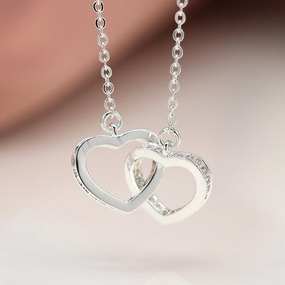 Silver plated crystal edged linked hearts necklace